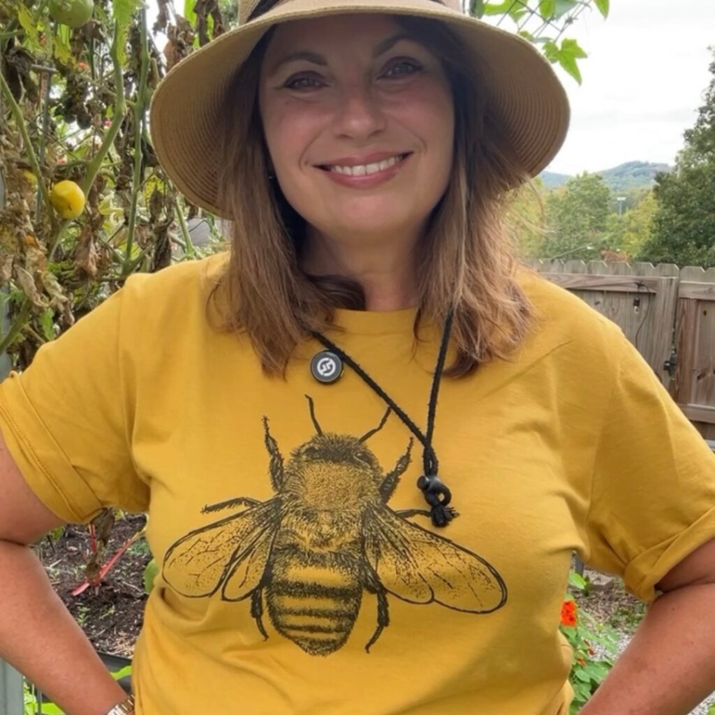 Woman with yellow honey bee shirt and brown hat