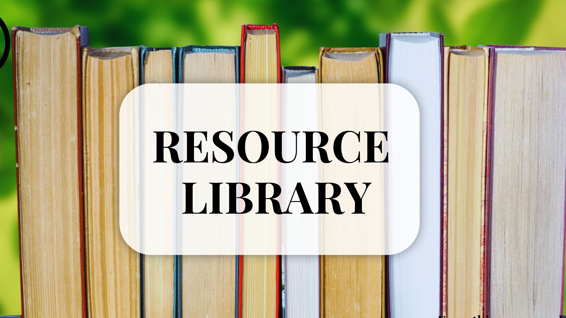 Line of books with pages facing viewer. Resource Library words on front on center of photo