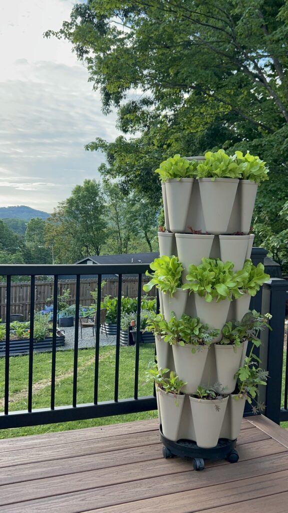 GreenStalk Vertical Planter in stone color with green plants