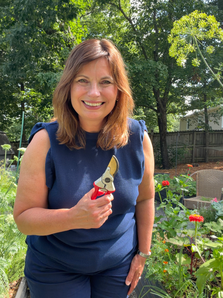 Michelle's garden grows holding garden shears