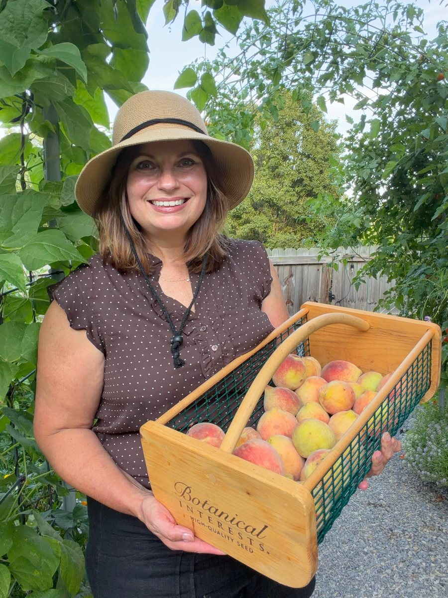 Michelle holding a basket of fresh peaches